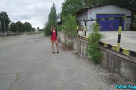 Pretty woman wearing a tiny red dress and standing on t