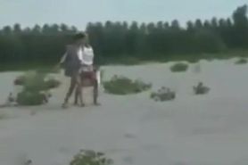 Two lesbians finger and lick each other on the beach