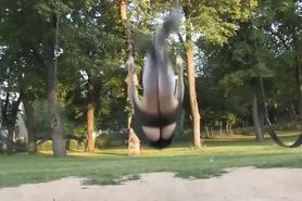 A young girl pees on a swing