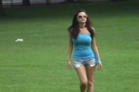 Dark haired beauty walking in park