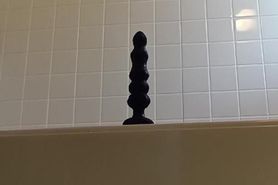 Wearing a leotard and inserting a into her anus