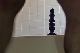 Wearing a leotard and inserting a into her anus