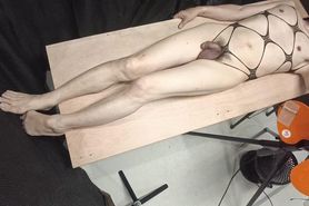 A cross-dressing guy whipping with rubber attached to t