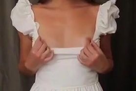 Young woman shows small tits