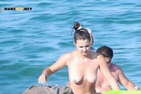 Busty nudist coming out of water
