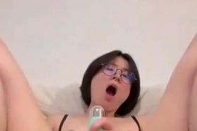 Cute Chinese in glasses masturbating with vibrator