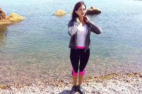 Girl gets wet in a tracksuit in the sea