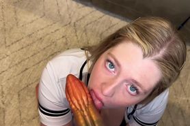 Giving head to an alien dildo