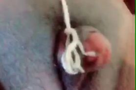 Clitoris clamped and tethered