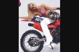 Dove Cameron In A Pink Bra Straddling A Bike