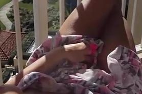 Woman jerking off her pussy on the balcony