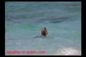 Busty milf topless on beach candid