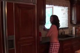 Busty redhead masturbates on kitchen table