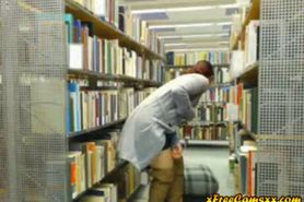 Hot redhead milf flashes and rubs pussy in library